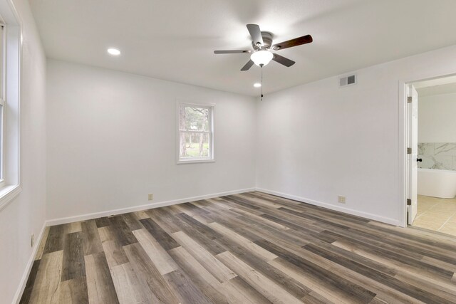 unfurnished room featuring ceiling fan and dark hardwood / wood-style floors