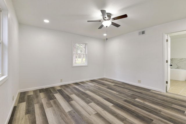 unfurnished room featuring recessed lighting, wood finished floors, visible vents, baseboards, and ceiling fan
