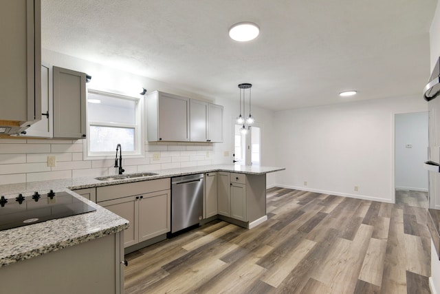 kitchen featuring sink, kitchen peninsula, pendant lighting, gray cabinets, and dishwasher