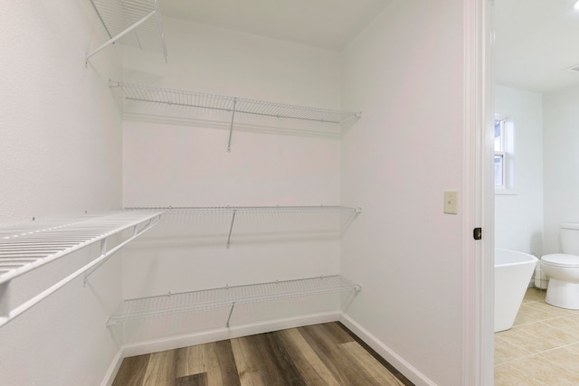 walk in closet featuring hardwood / wood-style floors