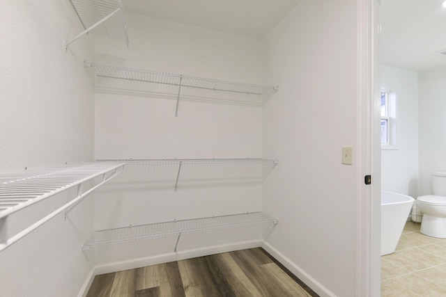 spacious closet with wood finished floors and visible vents