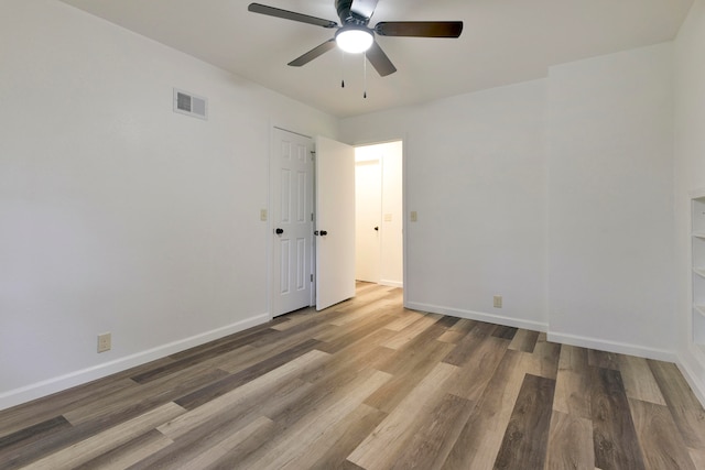 unfurnished room featuring hardwood / wood-style floors and ceiling fan