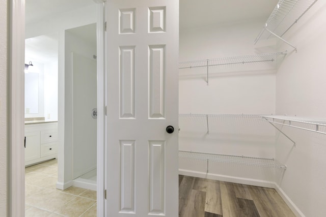 spacious closet featuring light wood-style flooring