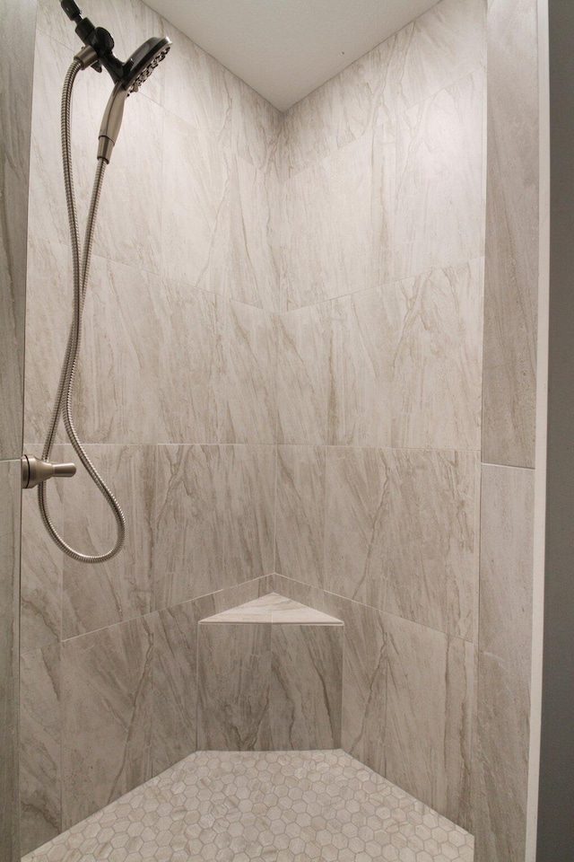 bathroom with a tile shower