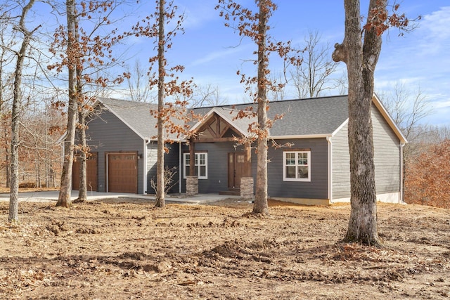 000 State Route Jj, West Plains, MO 65775 - view of front of house with a garage, driveway, and a shingled roof