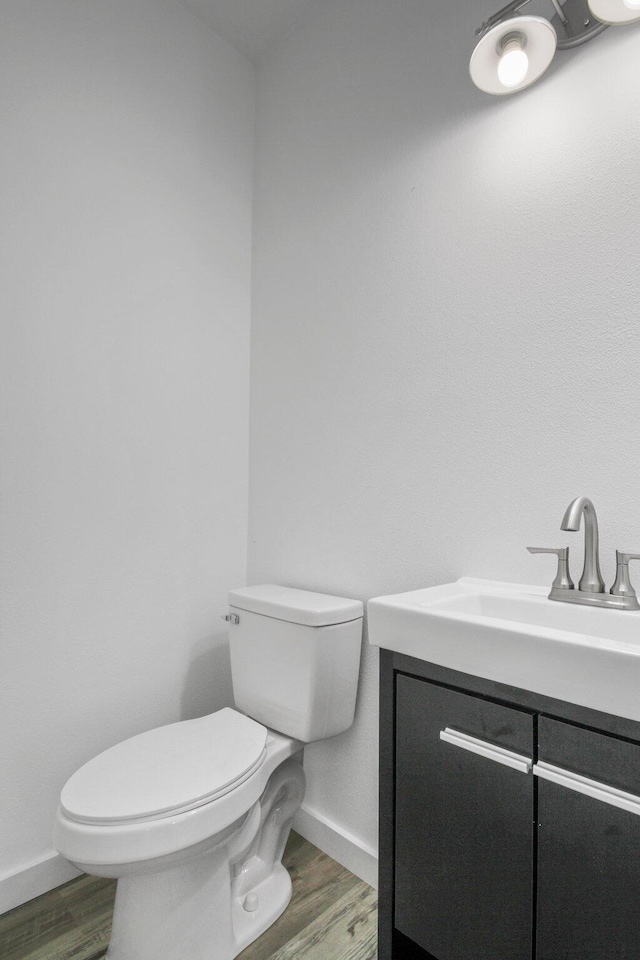 000 State Route Jj, West Plains, MO 65775 - half bath with baseboards, toilet, vanity, and wood finished floors