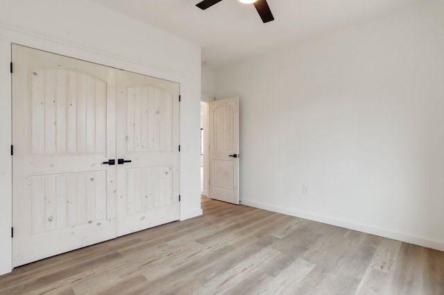 unfurnished bedroom with a closet, light hardwood / wood-style flooring, and ceiling fan