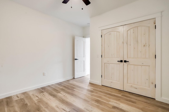 unfurnished bedroom with ceiling fan, a closet, and light hardwood / wood-style flooring