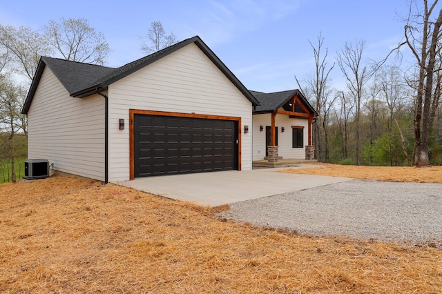 view of front of home featuring central AC unit and a garage