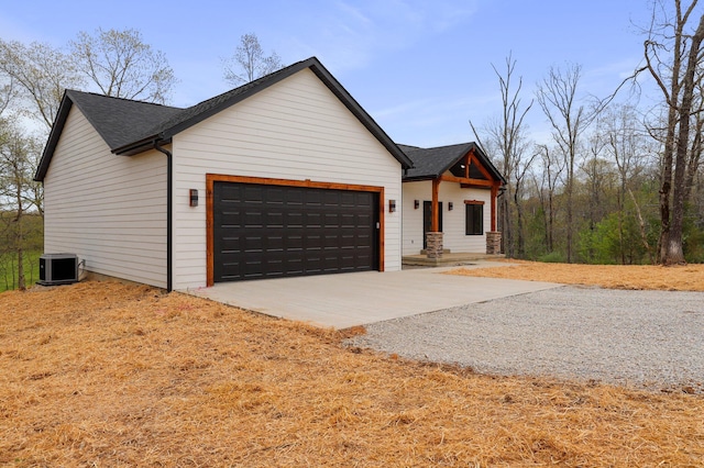 000 State Route Jj, West Plains, MO 65775 - view of front of property featuring gravel driveway, central AC unit, roof with shingles, and a garage