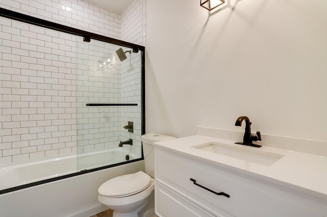 full bathroom with combined bath / shower with glass door, vanity, and toilet