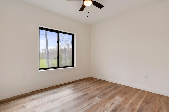 empty room featuring ceiling fan and light hardwood / wood-style floors