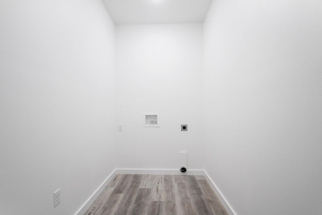 clothes washing area featuring hookup for a washing machine, light hardwood / wood-style flooring, and electric dryer hookup