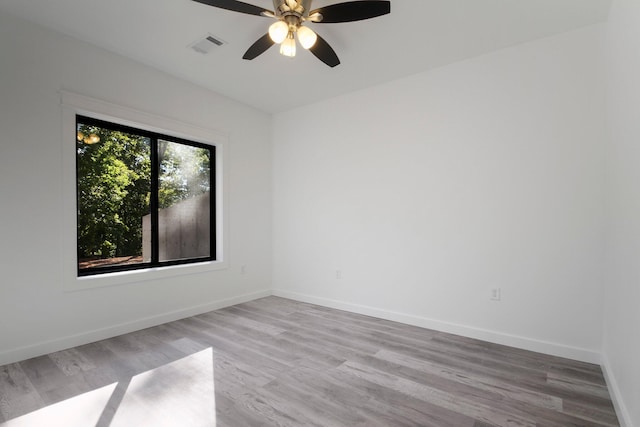 empty room with light hardwood / wood-style floors and ceiling fan