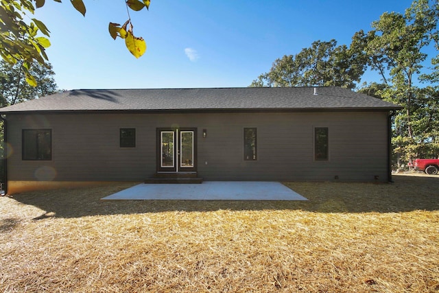 rear view of house featuring french doors, a lawn, and a patio area