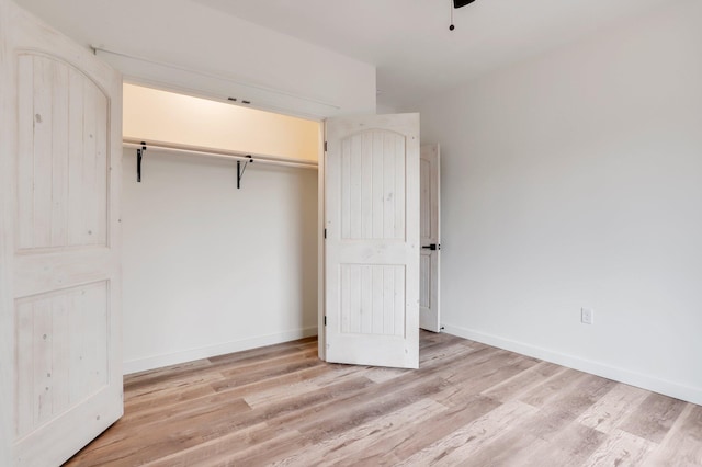 unfurnished bedroom with a closet and light hardwood / wood-style flooring