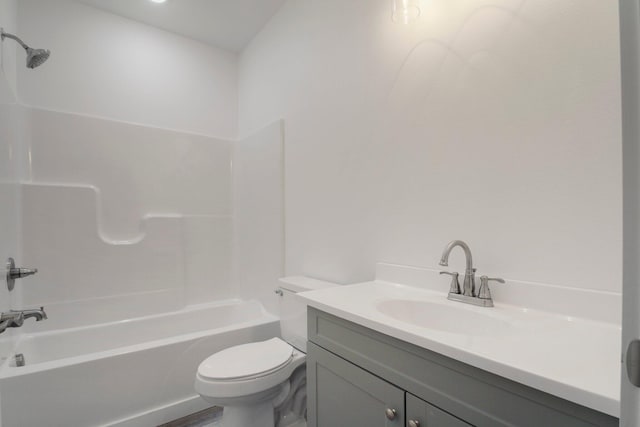 full bathroom featuring bathing tub / shower combination, vanity, and toilet