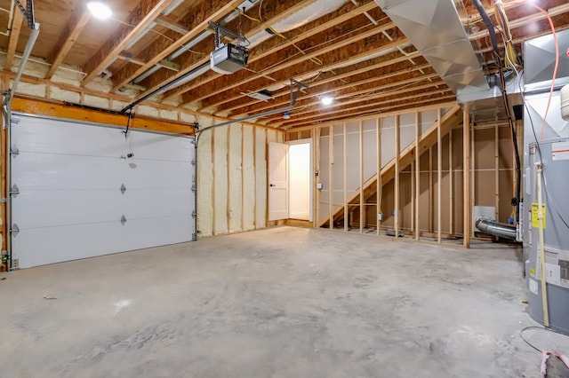 garage with gas water heater and a garage door opener