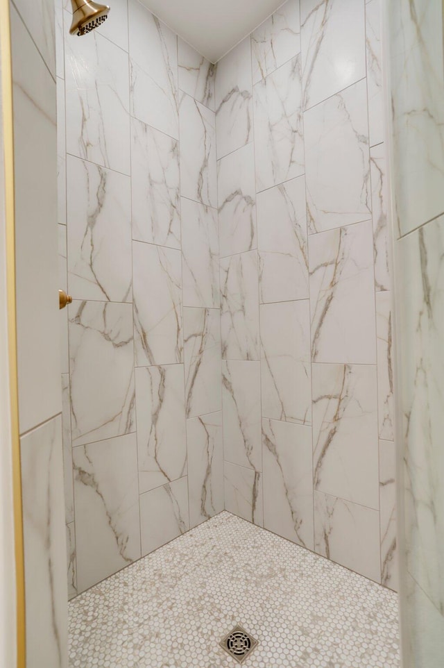 bathroom with a tile shower