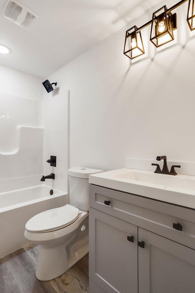 000 State Route Jj, West Plains, MO 65775 - full bathroom featuring wood finished floors, vanity, toilet, shower / bathtub combination, and visible vents