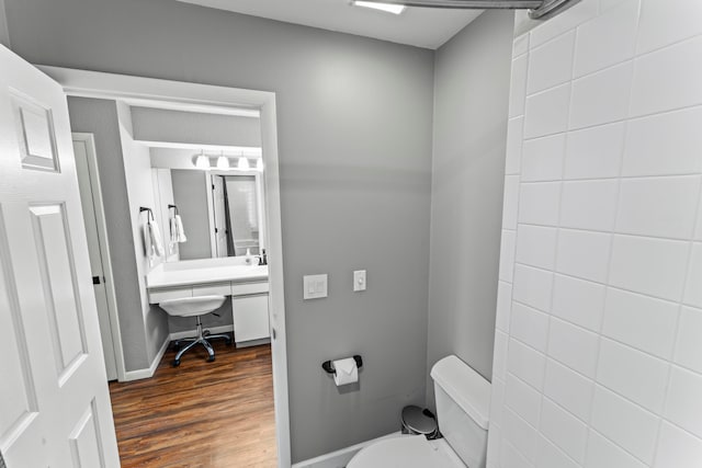 bathroom with toilet and wood-type flooring