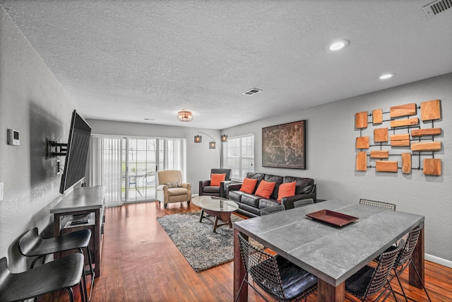 living room featuring hardwood / wood-style flooring and a textured ceiling