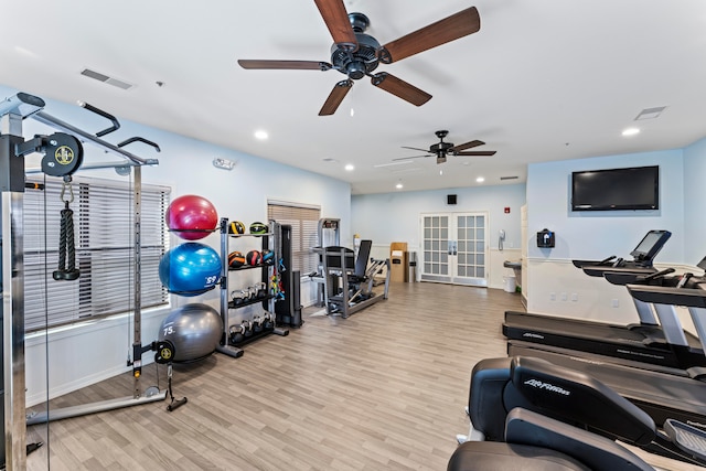 exercise room with ceiling fan, french doors, and light hardwood / wood-style floors