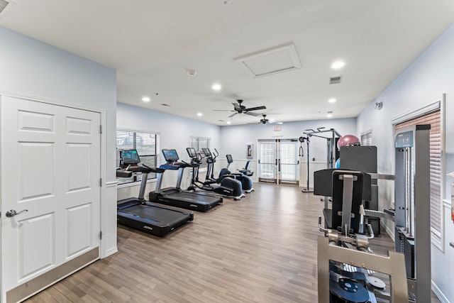 gym featuring ceiling fan, light wood-type flooring, and a healthy amount of sunlight