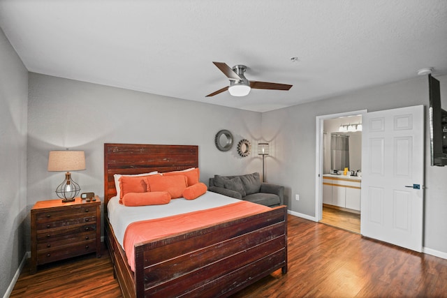 bedroom featuring dark wood-type flooring, ceiling fan, and ensuite bath