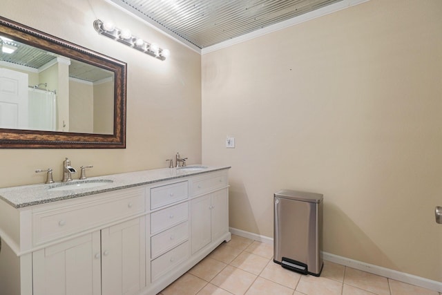 bathroom with crown molding, tile patterned floors, and vanity