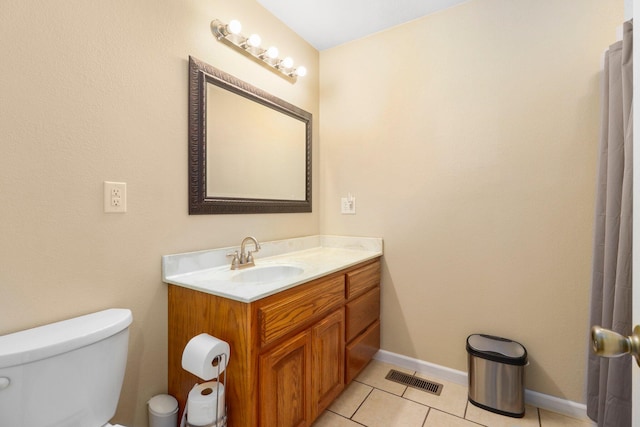 bathroom with tile patterned floors, vanity, and toilet