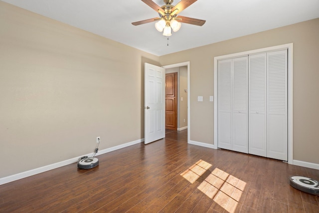 unfurnished bedroom with a closet, dark hardwood / wood-style floors, and ceiling fan