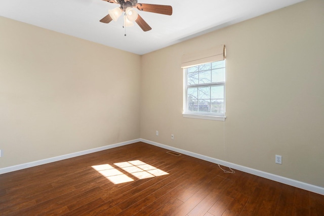 empty room featuring ceiling fan and dark wood-type flooring