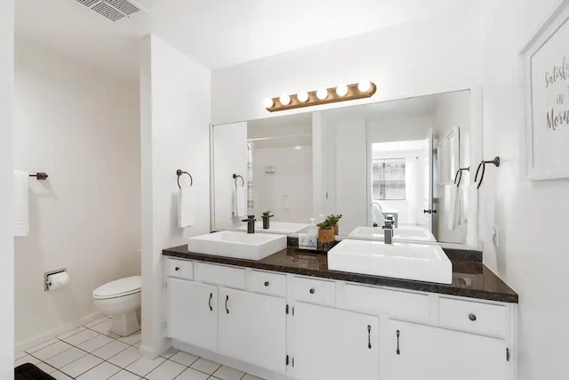 bathroom featuring tile patterned floors, vanity, and toilet