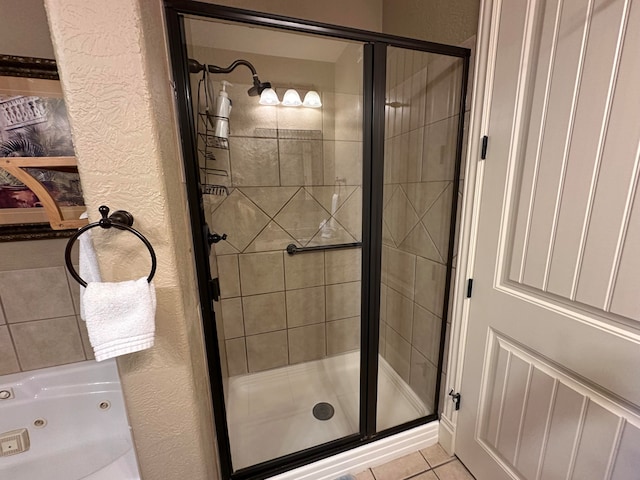 bathroom featuring tile patterned flooring and an enclosed shower