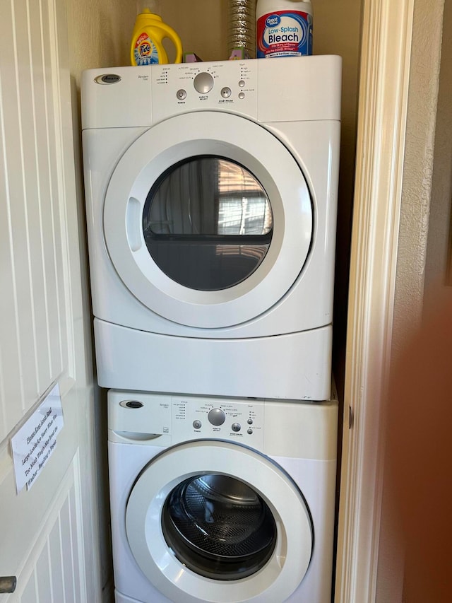 clothes washing area with stacked washer / drying machine