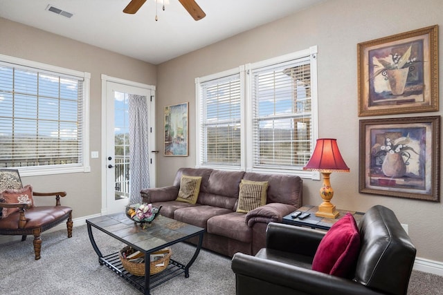 carpeted living room featuring a wealth of natural light and ceiling fan