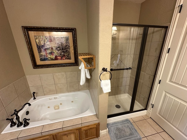 bathroom with separate shower and tub and tile patterned flooring