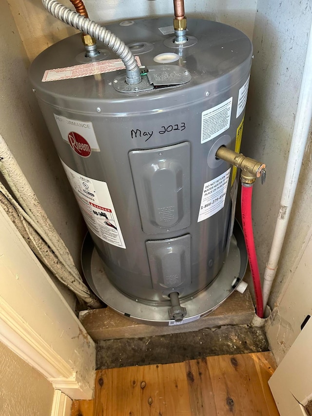 utility room with electric water heater