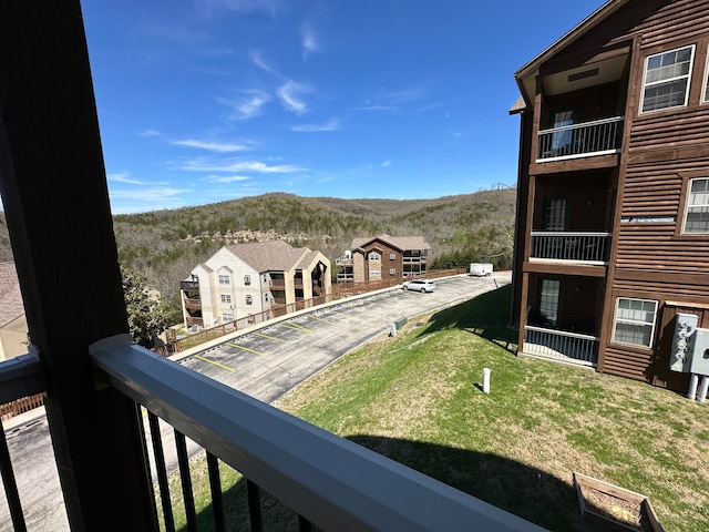 exterior space with a balcony and a mountain view