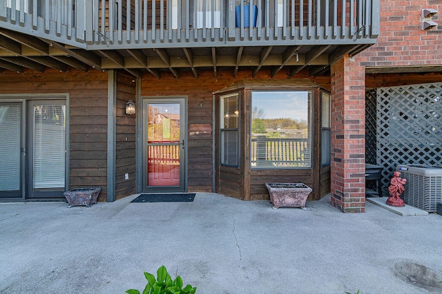 property entrance featuring a balcony and a patio area