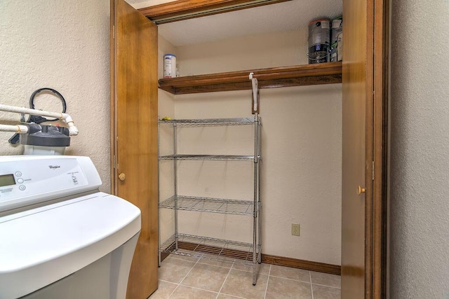 150 Sunken Forest Dr Unit 10-242, Forsyth, MO 65653 - clothes washing area with baseboards, a textured wall, light tile patterned floors, and laundry area