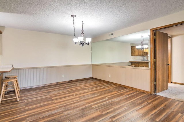150 Sunken Forest Dr Unit 10-242, Forsyth, MO 65653 - interior space with visible vents, wood finished floors, a chandelier, and a textured ceiling