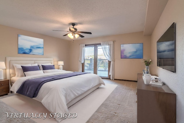 bedroom featuring access to outside, a textured ceiling, and ceiling fan