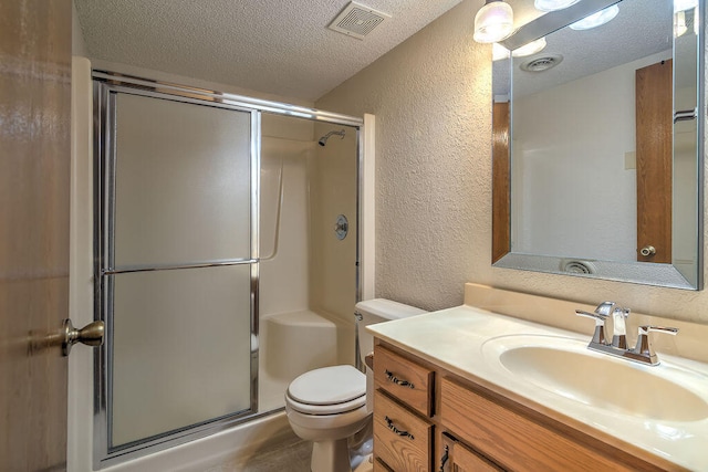 bathroom with a textured ceiling, toilet, an enclosed shower, and vanity