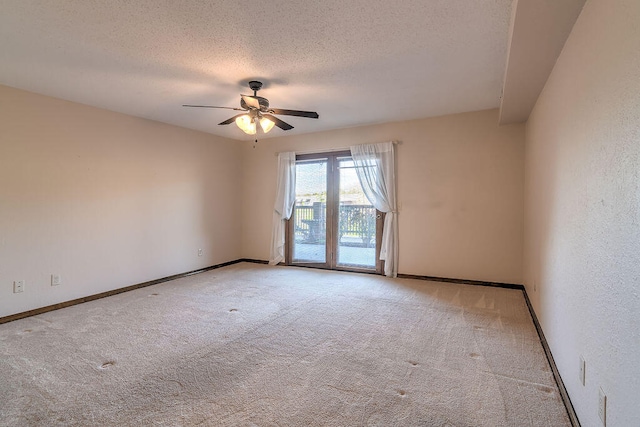 carpeted spare room featuring ceiling fan and a textured ceiling