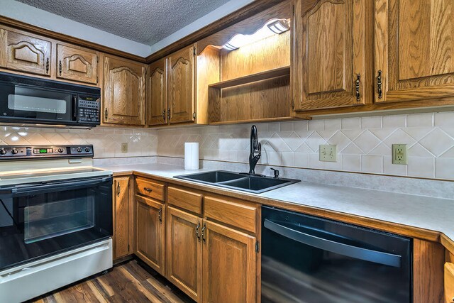 kitchen with sink, a textured ceiling, black appliances, dark hardwood / wood-style floors, and decorative backsplash