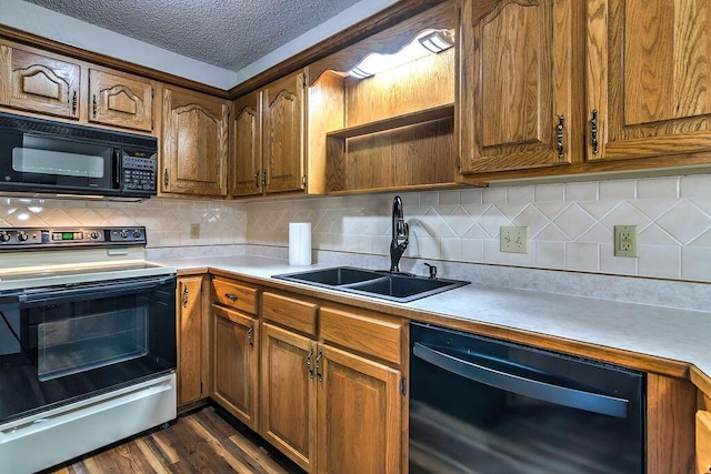 150 Sunken Forest Dr Unit 10-242, Forsyth, MO 65653 - kitchen with a sink, black appliances, decorative backsplash, light countertops, and dark wood finished floors