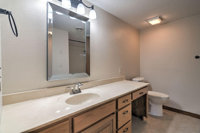 bathroom featuring vanity, toilet, a textured ceiling, and tile patterned floors