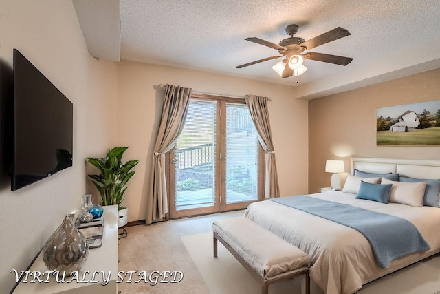 bedroom featuring ceiling fan, access to outside, and a textured ceiling